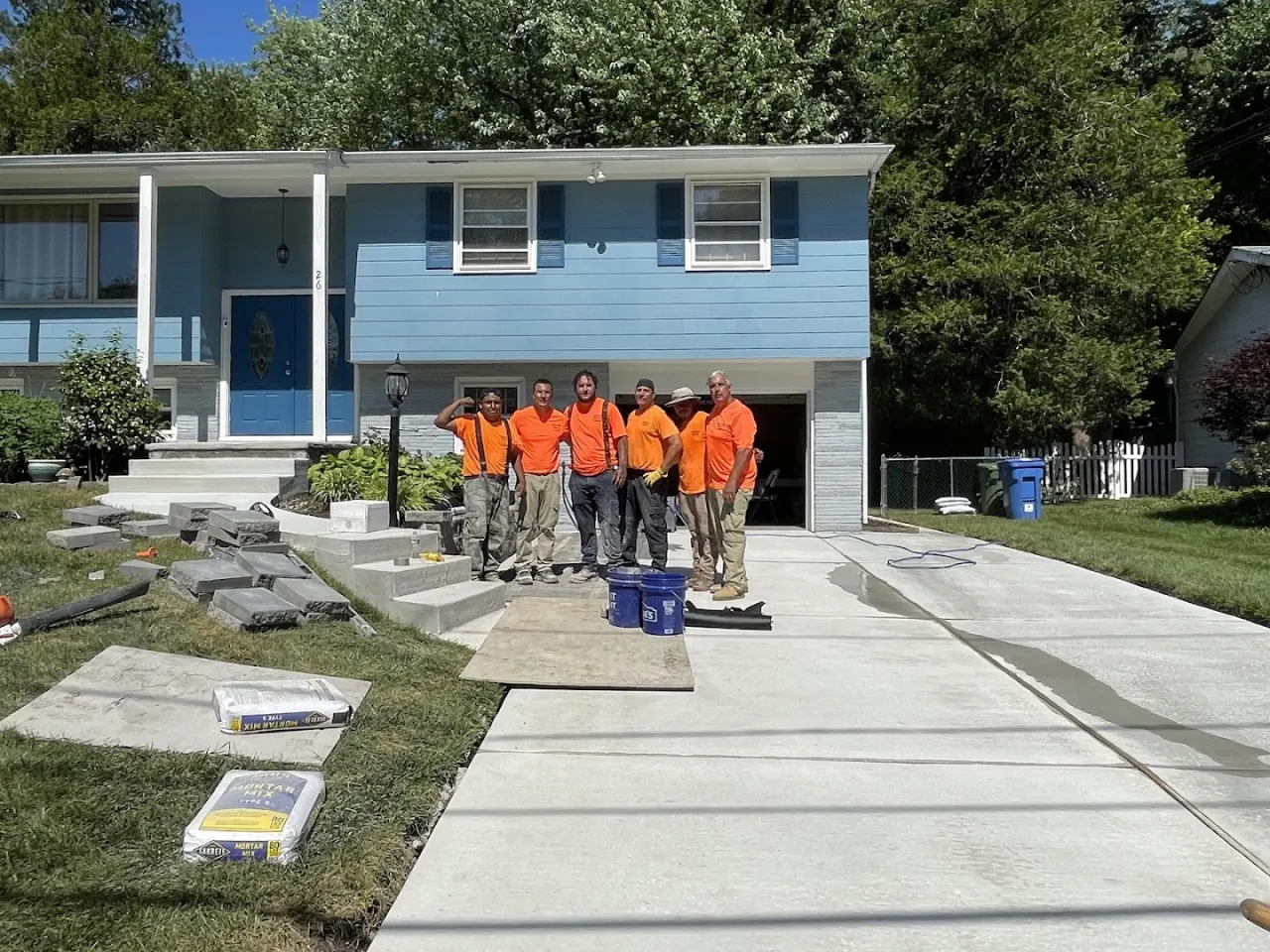The Papaneri family crew in front of a completed driveway and walkway in South Jersey